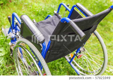 Empty wheelchair standing on grass in hospital Empty wheelchair standing on grass in hospital 57821049