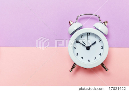 Vintage alarm clock Isolated on purple pink pastel 57821622