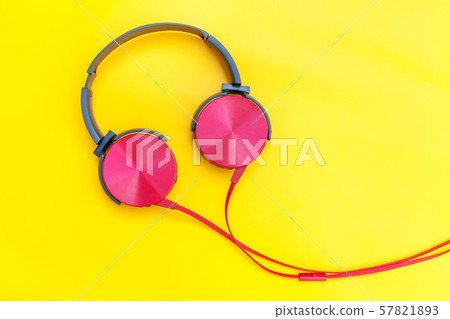 Red headphones with cable isolated on yellow Red headphones with cable isolated on yellow 57821893
