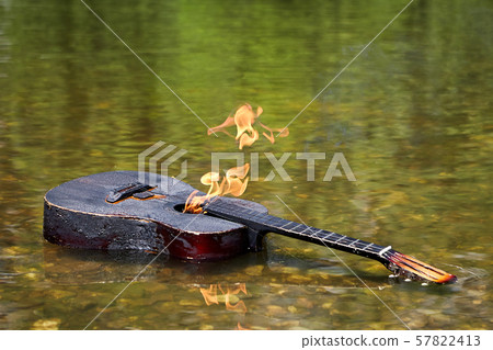 A burning guitar lies in the water. A burning guitar lies in the water. 57822413