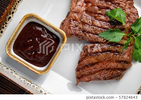 Steak on the bone with red sauce. restaurant menu Steak on the bone with red sauce. restaurant menu 57824643