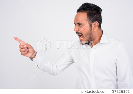 Studio shot of angry bearded Indian businessman shouting and pointing finger 57826361
