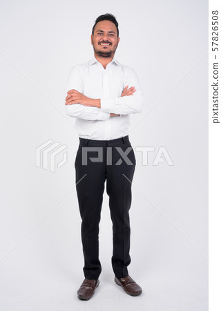Full body shot of happy bearded Indian businessman smiling Full body shot of happy bearded Indian businessman smiling 57826508