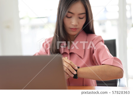 Young asian businesswoman checking the time, work 57828363
