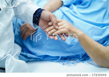 Holding Touching hands Asian senior or elderly old lady woman patient with love, care, helping, encourage and empathy at nursing hospital ward Holding Touching hands Asian senior or elderly old lady woman patient with love, care, helping, encourage and empathy at nursing hospital ward 57830949