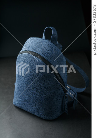 Blue backpack made of genuine leather on a dark Blue backpack made of genuine leather on a dark 57832678