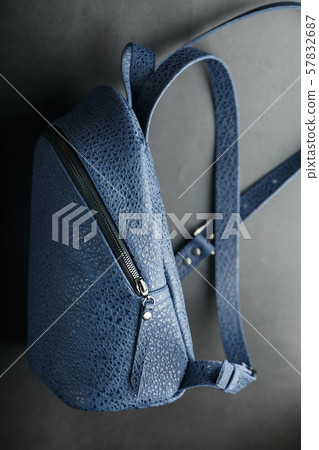 Blue backpack made of genuine leather on a dark Blue backpack made of genuine leather on a dark 57832687