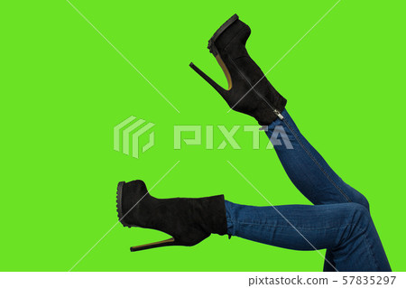 A lovely young muscular brunette stretches and flexes with her back to the camera. 57835297