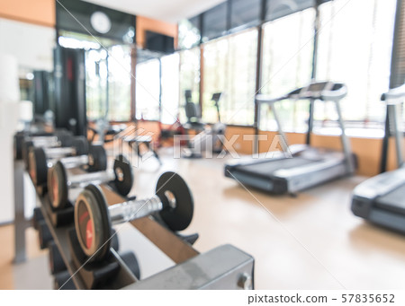 Blur gym background fitness center or health club with blurry sports exercise equipment for aerobic workout and bodybuilding Blur gym background fitness center or health club with blurry sports exercise equipment for aerobic workout and bodybuilding 57835652