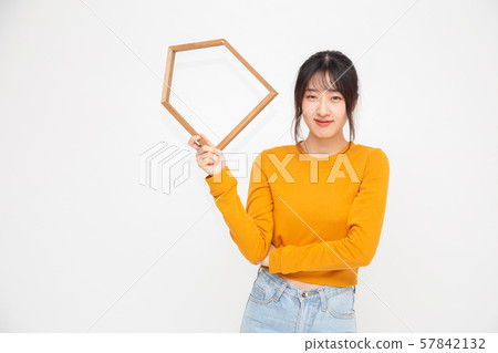 Chinese Asian woman holding homes model isolated 57842132