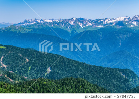 Top view of the mountain range and peaks covered with snow 57847753