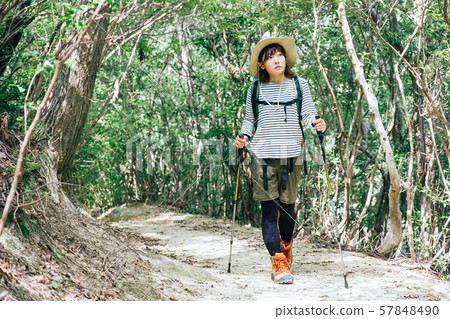 Young woman climbing a mountain 57848490