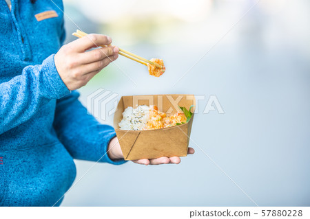 Young mans hands holding lunch in a box of Young mans hands holding lunch in a box of 57880228