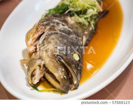 Fish in soy sauce, served on white plate Fish in soy sauce, served on white plate 57888123