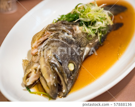 Fish in soy sauce, served on white plate Fish in soy sauce, served on white plate 57888136