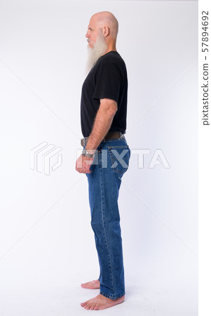 Full body shot profile view of mature bald man with long gray beard Full body shot profile view of mature bald man with long gray beard 57894692