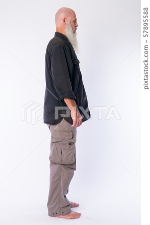 Full body shot profile view of mature bald man with long gray beard Full body shot profile view of mature bald man with long gray beard 57895588