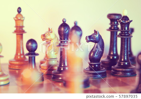 Old wooden chessmen on the chess board Old wooden chessmen on the chess board 57897035