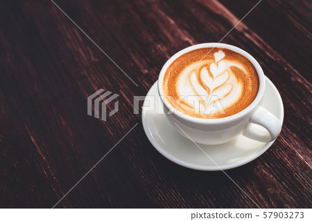 Cup of cappuccino on wooden table. Cup of cappuccino on wooden table. 57903273