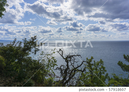 Beautiful view of the Black Sea from top of the hill of the green rain forest. Sun light reflection. 57918607