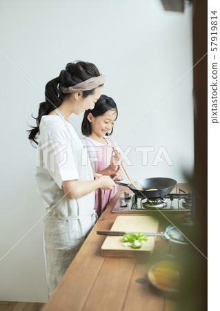 Parent and child mother daughter cooking 57919814