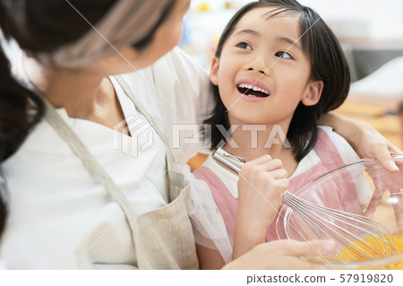 Parent and child mother daughter cooking 57919820