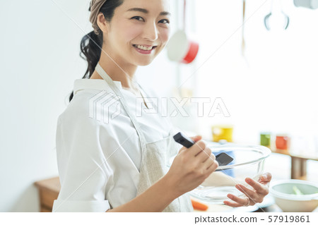 Female housewife cooking Female housewife cooking 57919861