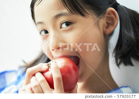 Girl child eating 57920177