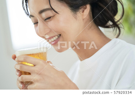 Woman drinking beer Woman drinking beer 57920334