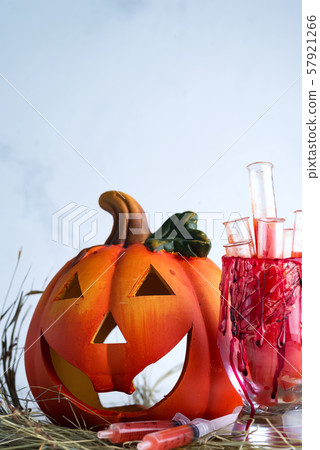 Halloween bloody glass with test tubes of tomato juice and with pumpkin jack . Party drinks on dry Halloween bloody glass with test tubes of tomato juice and with pumpkin jack . Party drinks on dry 57921266