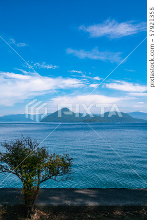 A beautiful view of the caldera lake and Nakajima Island from the shores of Lake Toya in Hokkaido. 57921358