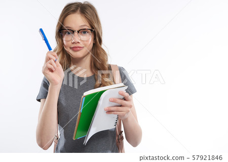 Charming teen girl in glasses having good idea Charming teen girl in glasses having good idea 57921846