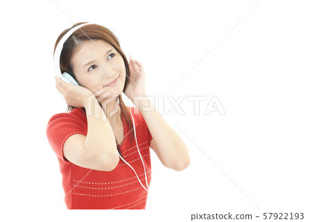 A smiling woman listening to music A smiling woman listening to music 57922193