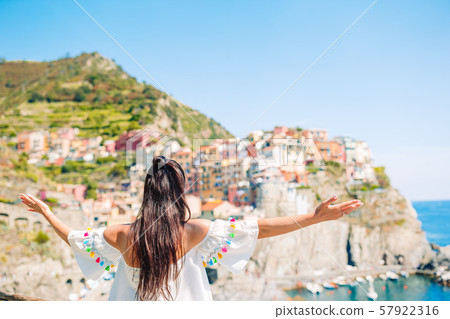 Tourist looking at scenic view of Manarola, Cinque Terre, Liguria, Italy Tourist looking at scenic view of Manarola, Cinque Terre, Liguria, Italy 57922316