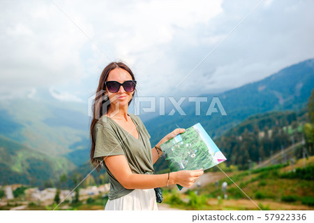 Happy young woman in mountains in the background of fog 57922336