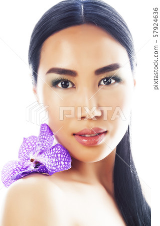 young pretty asian woman with flower purple orchid close up isolated spa, womans day concept young pretty asian woman with flower purple orchid close up isolated spa, womans day concept 57924636