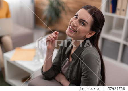 High angle of happy brunette patient is satisfied at psychology seance indoors High angle of happy brunette patient is satisfied at psychology seance indoors 57924738