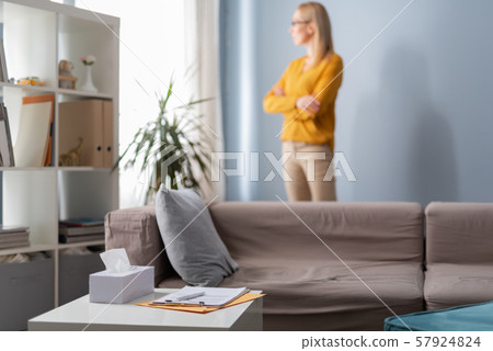 Table with clipboard and napkins in cabinet with psychologist on background Table with clipboard and napkins in cabinet with psychologist on background 57924824