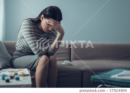 Sad brunette woman tilting her head forward during art therapy session Sad brunette woman tilting her head forward during art therapy session 57924904