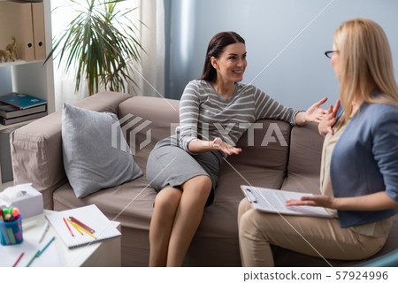 Patient talking about positive changes in life to her psychologist Patient talking about positive changes in life to her psychologist 57924996