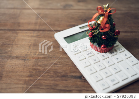 A beautifully decorated Christmas tree placed on a A beautifully decorated Christmas tree placed on a 57926398