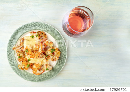 Shrimps with a glass of rose wine, shot from the top with a place for text Shrimps with a glass of rose wine, shot from the top with a place for text 57926701