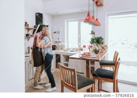Beautiful couple in love hugging in kitchen at home 57926818