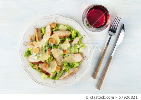 Chicken Caesar salad, overhead shot with a glass of wine 57926821