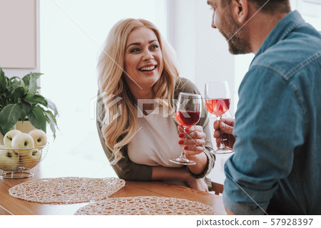 Beautiful blond woman with alcoholic drink spending time with husband at home 57928397