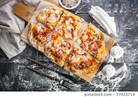 Peperroni pizza on a cutting board on a dark 57928719