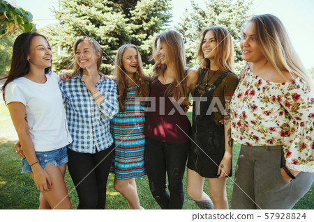 Happy women outdoors on sunny day. Girl power concept. Happy women outdoors on sunny day. Girl power concept. 57928824
