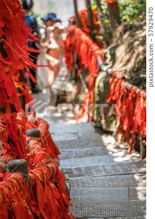 Red ribbons along trail in mountains in 57929470