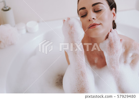 Close up of a delighted woman taking bath 57929480