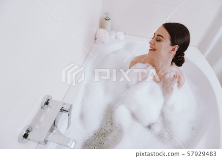 Top view of a nice overjoyed woman taking bath Top view of a nice overjoyed woman taking bath 57929483